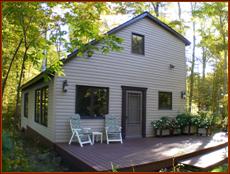 "Front" and deck side views of dwelling. Both sides here overlook the lake which is behind the camera in this shot.