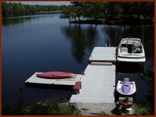 Expansive 36-foot main dock is a full eight feet wide, over-built for longevity and perfect for entertaining. Additional modular/reconfigurable dock with lower freeboard for smaller crafts. There is a lift with winch for the sea-doo and a cruiser-grade Naylor marine railway with 230-volt electric winch for larger craft.