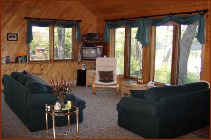 Living Room with views of lake thru six large windows.