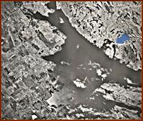 In this satellite photo of Big Rideau Lake, the arrow shows location of the subject property at the back of sheltered Bass Bay on the north shore.